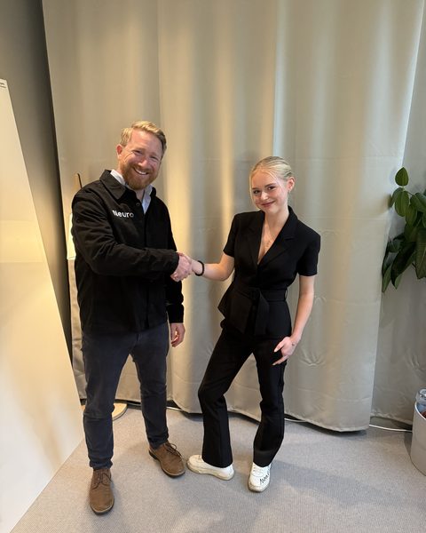 Tommy and Erika shaking hands in the office.